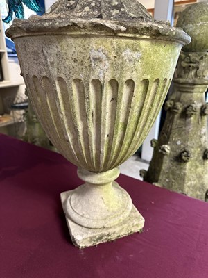 Lot 1941 - Antique Coade stone urn, the foliate knop above a domed cover and fluted body, circular socle and square base, approximately 60cm high