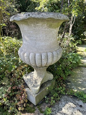 Lot 1942 - Pair of antique stone garden urns with half reeded bodies, on square bases, 61cm high