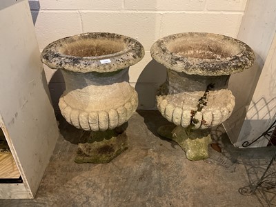 Lot 1942 - Pair of antique stone garden urns with half reeded bodies, on square bases, 61cm high