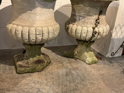 Lot 1942 - Pair of antique stone garden urns with half reeded bodies, on square bases, 61cm high