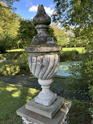 Lot 1949 - Pair of antique garden urns of wrythen fluted form, on square bases and superstate square plinths, 100cm high overall