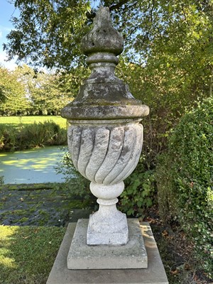 Lot 1949 - Pair of antique garden urns of wrythen fluted form, on square bases and superstate square plinths, 100cm high overall