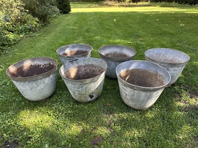 Lot 1950 - Set of eight galvanised garden planters of slightly tapered form, on circular bases, 35cm high