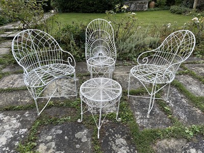 Lot 1957 - Group of white painted wire-work garden furniture comprising two elbow chairs, a standard chair and a low round table (4)