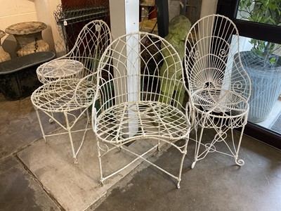 Lot 1957 - Group of white painted wire-work garden furniture comprising two elbow chairs, a standard chair and a low round table (4)
