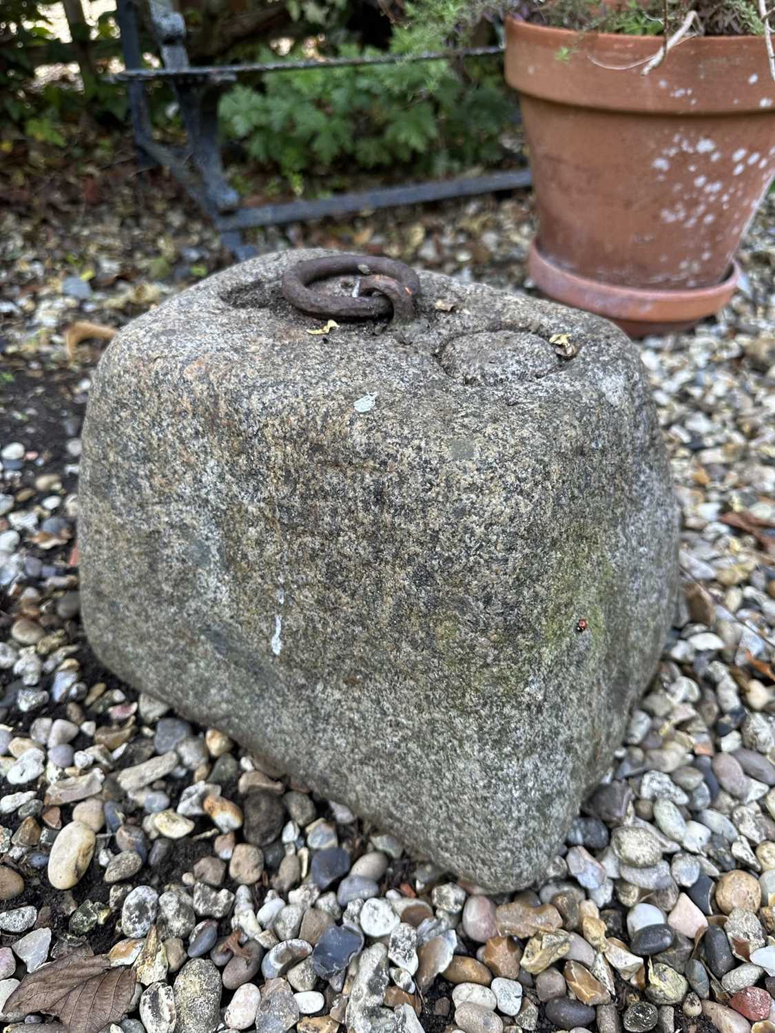 Lot 1961 - Antique granite weight of rectangular tapered form with iron ring handle, 23cm high