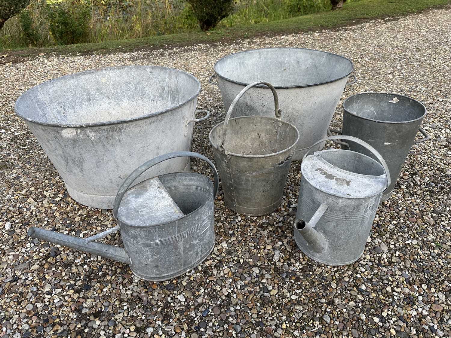 Lot 1965 - Two antique galvanised twin handled planters, galvanised bucket, another and two watering cans (6)