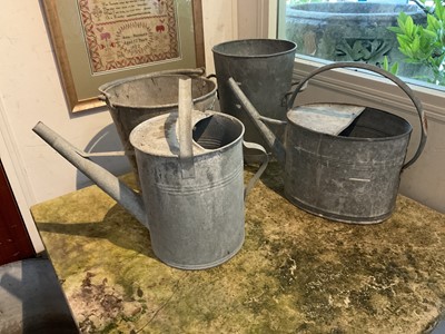 Lot 1965 - Two antique galvanised twin handled planters, galvanised bucket, another and two watering cans (6)