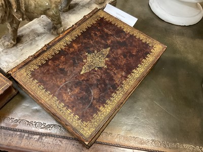 Lot 1882 - Two deceptive book boxes, the 18th century leather bound tomes adapted with internal spaces to hide secrets, largest 29cm high