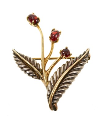 Lot 519 - Tiffany & Co silver and 18ct gold foliate brooch set with three garnet cabochons, stamped 750, 925, Italy and dated 2003 (London hallmarks)