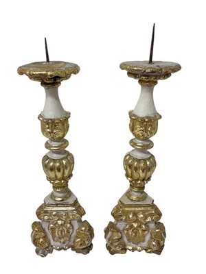 Lot 935 - Pair of antique Italian gilt and white painted alter candlesticks