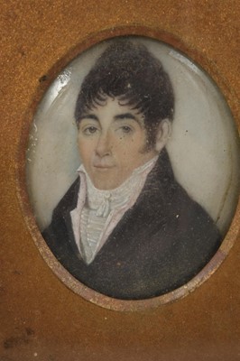 Lot 843 - Early 19th century portrait miniature on ivory, depicting a gentleman in white cravat and overcoat