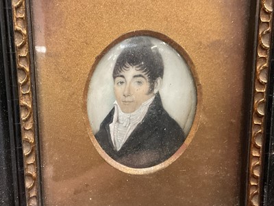 Lot 843 - Early 19th century portrait miniature on ivory, depicting a gentleman in white cravat and overcoat