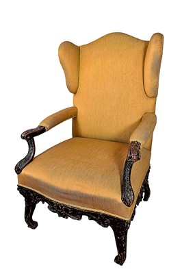 Lot 1440 - 18th century Continental wing armchair, with heavily carved scroll arms on cabriole legs