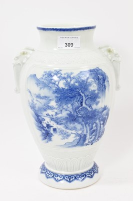 Lot 309 - Japanese blue and white Hirado porcelain vase, finely painted with landscape scenes, with moulded foo dog handles on an incised patterned ground, 28.25cm high