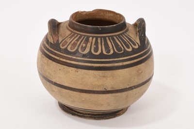 Lot 311 - Small Greek ceramic round pot with two lug handles, with banding to body and foliate pattern to neck, probably Ancient, old label to base, 7cm high