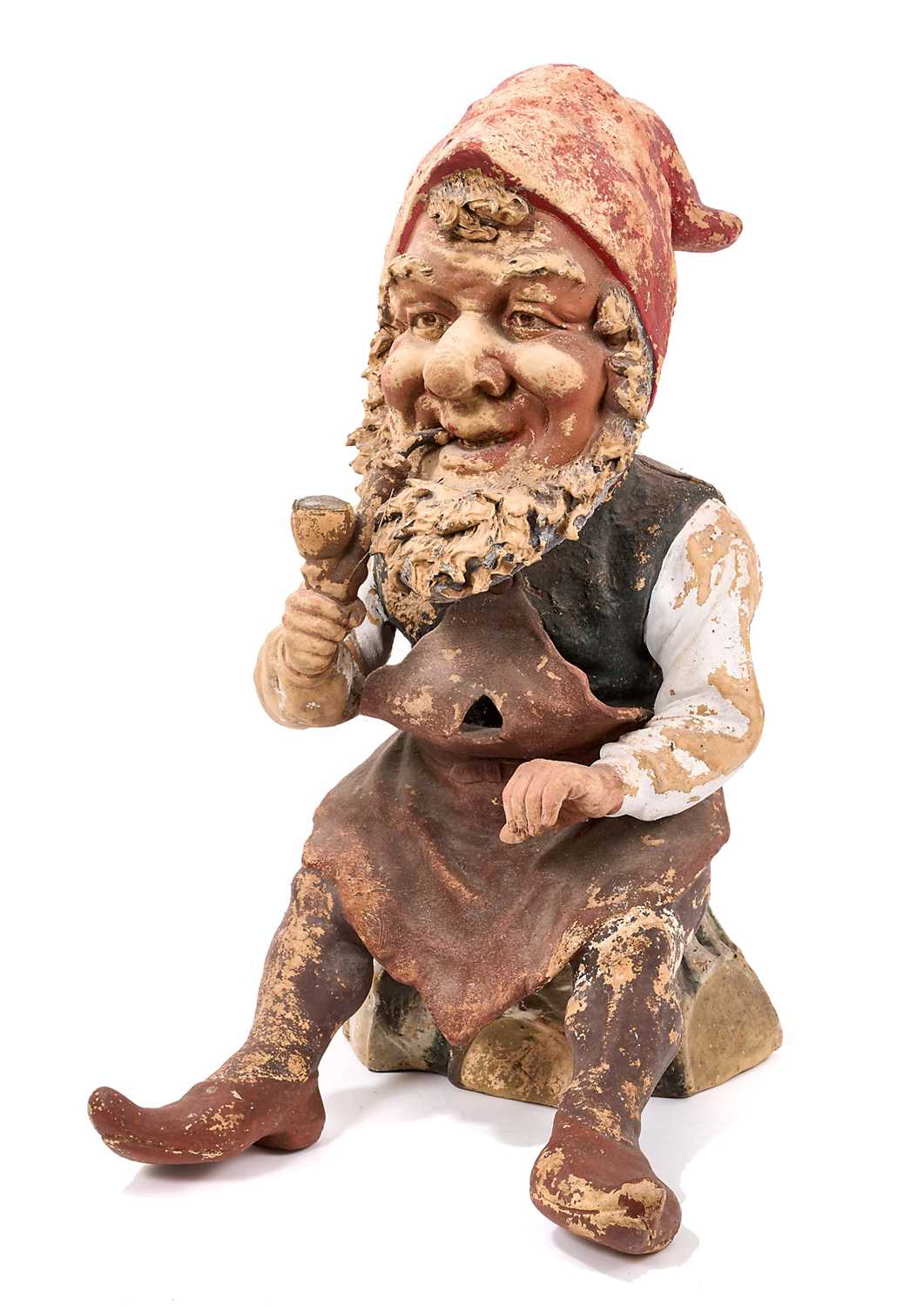 Lot 1259 - Antique German terracotta garden gnome, in seated repose, with pipe