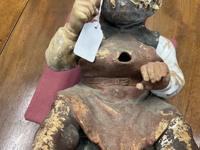 Lot 1259 - Antique German terracotta garden gnome, in seated repose, with pipe