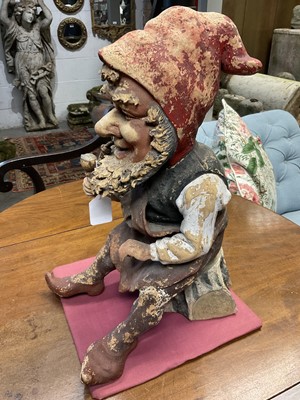 Lot 1259 - Antique German terracotta garden gnome, in seated repose, with pipe