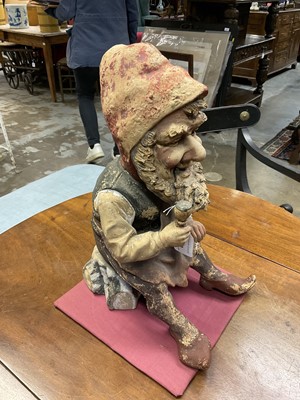 Lot 1259 - Antique German terracotta garden gnome, in seated repose, with pipe