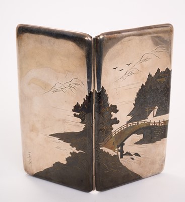Lot 498 - Mid 20th century Japanese silver and niello cigarette case of rectangular form, decorated with a scene depicting mountains, with a bridge over water in the foreground, the case stamped Sterling...