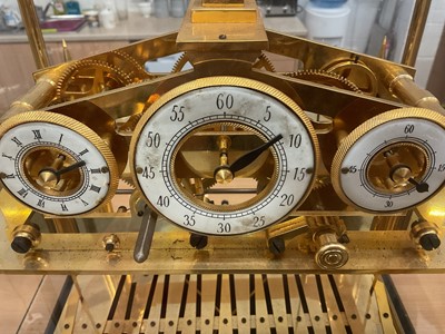 Lot 809 - Impressive Chinese Congreve-style rolling ball clock with enamel dials in glazed brass framed case 49 x 37 x 37 cm with key
