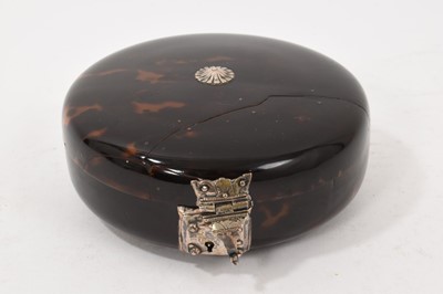 Lot 841 - Early tortoiseshell and silver mounted table snuff box, of domed form with central boss and ornate lock, elaborate old repair to the cover, probably late 17th/early 18th century, 13cm diameter