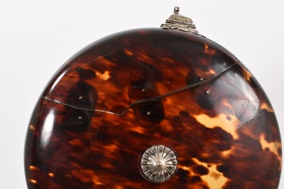 Lot 841 - Early tortoiseshell and silver mounted table snuff box, of domed form with central boss and ornate lock, elaborate old repair to the cover, probably late 17th/early 18th century, 13cm diameter