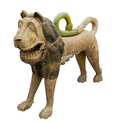 Lot 1285 - Antique Indian carved hardwood figure of a lion, with polychrome elements and anatomically correct, approximately 122cm long, 82cm high