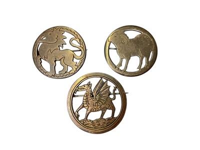 Lot 171 - Three 1930s silver circular brooches depicting a dragon, a lion and a sheep by Henry George Murphy, all bearing the Falcon studio mark, 32mm diameter