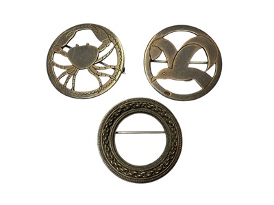 Lot 172 - Three 1930s silver circular brooches depicting a crab, a seagull and a wreath by Henry George Murphy, all bearing the Falcon studio mark, 32mm diameter