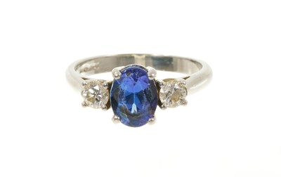Lot 433 - Tanzanite and diamond three stone ring in platinum setting