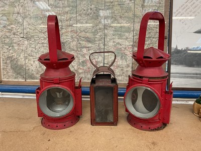 Lot 2905 - Two vintage red-painted railway lamps and one other lamp