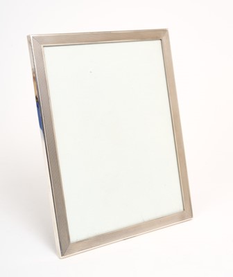 Lot 244 - Large Elizabeth II silver photograph frame of rectangular form with engine turned decoration
