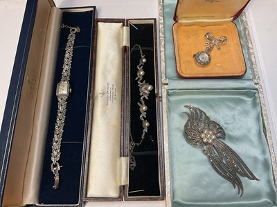 Lot 67 - Group of 1950s silver marcasite jewellery to include a Sonic pendant watch, necklace and large spray brooch, together with a stainless steel marcasite Ormo cocktail watch (4)