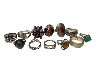 Lot 11 - Twelve silver and white metal dress rings including amethyst, amber, tiger's eye etc