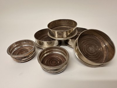 Lot 357 - Set of four 19th century style silver plated coasters with turned wooden bases, together with a pair of plated bottle coasters (6)