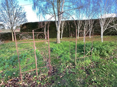 Lot 1537 - Wrought iron arbour with central arch and scroll decoration 319cm wide x 235cm high