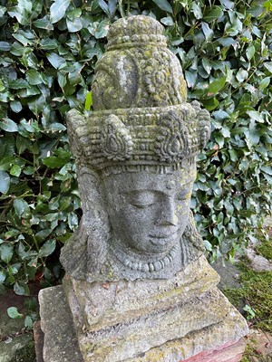 Lot 1531 - Eastern carved stone Buddhistic head, approximately 47cm high on later plinth