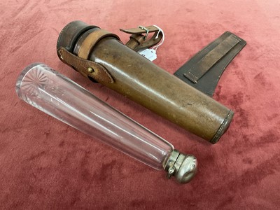 Lot 909 - Brown leather cased glass saddle flask with silver plated top, for saddle mounting