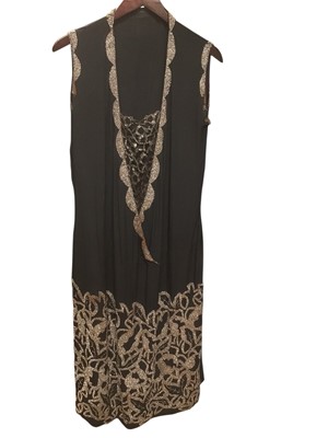 Lot 2500 - 1920s black cocktail dress heavily embroidered with steel seed beads in an abstract floral design, drop waist and metallic lace front insert.