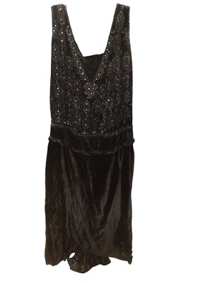 Lot 2501 - 1920s black velvet evening dress embroidered with rhinestones and steel beads in geometric design, beaded train to reverse and drop waist.