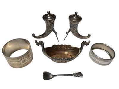 Lot 54 - Norwegian silver cornucopia-shape salt and pepper pots, Norwegian silver boat-shape salt and spoon, and two silver napkin rings