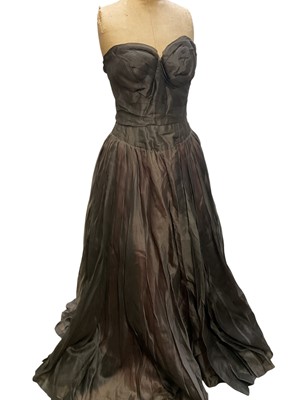 Lot 2507 - Designer Eliane Montigny, 1950s evening gown in cream and green abstract floral silk, full stiffened petticoats and bow at back. 1950's strapless evening gown in grey and pink abstract design, b...