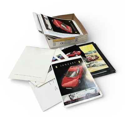 Lot 143 - Large selection of unframed Ferrari promotional photographs, Aston Martin, Ferrari and other official calendars and related items, (1 box).