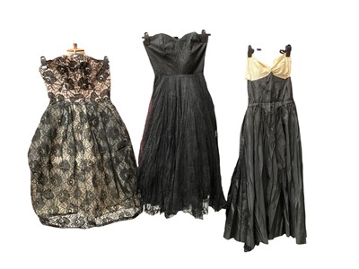 Lot 2511 - Two 1950s short strapless dresses with bone bodices and full gathered skirts with stiffened underskirts. Plus another strapless gown.