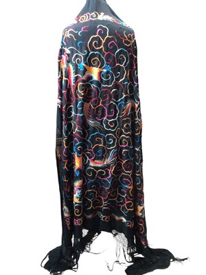 Lot 2517 - Chinese double sided black embroidered silk shawl with tassels, dragons and clouds, early 20th century, 120 x 130cms exc. tassels.