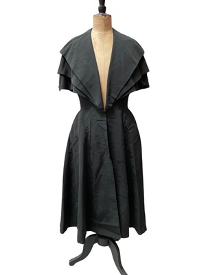 Lot 2518 - Designer Lachasse black coat with classic nipped in waist, triple layered collar and full skirt, Lachasse grey suit fitted peplum jacket, skirt has water mark front and back. Plus a Loiusodec b...