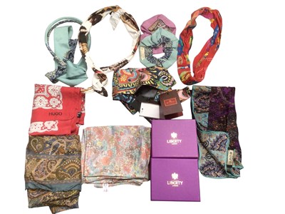 Lot 2560 - Selection of designer silk scarves scarves including Etro Arizone 7x140 cm new with tags, other Etro scarves and hair bands, Etro wool wrap, tow small Lberty boxes, two Liberty scarves, two Salv...
