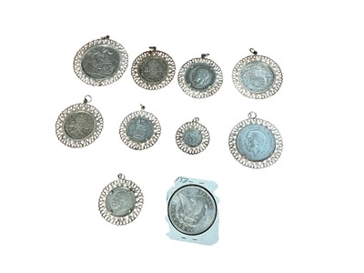 Lot 609 - World - Mixed silver G.B. coins in white metal pendant mounts, to include Victoria JH Crown 1889 VG and an unmounted U.S. silver Dollar 1881o AU (10 coins)